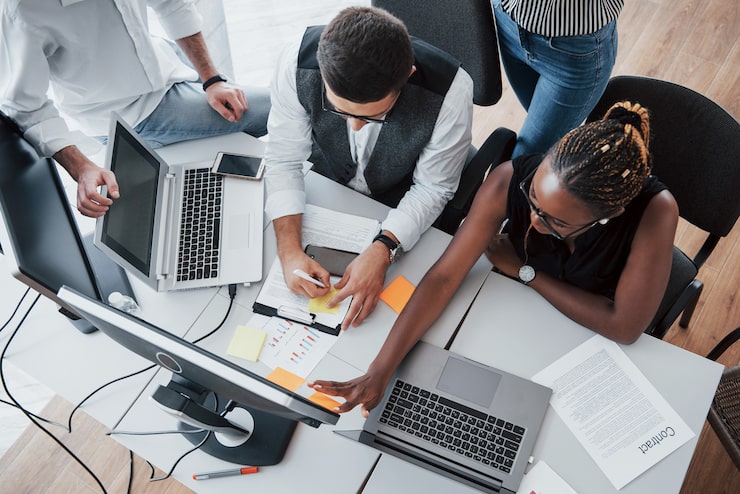 Multinational cohort working together in a collaborative office setting